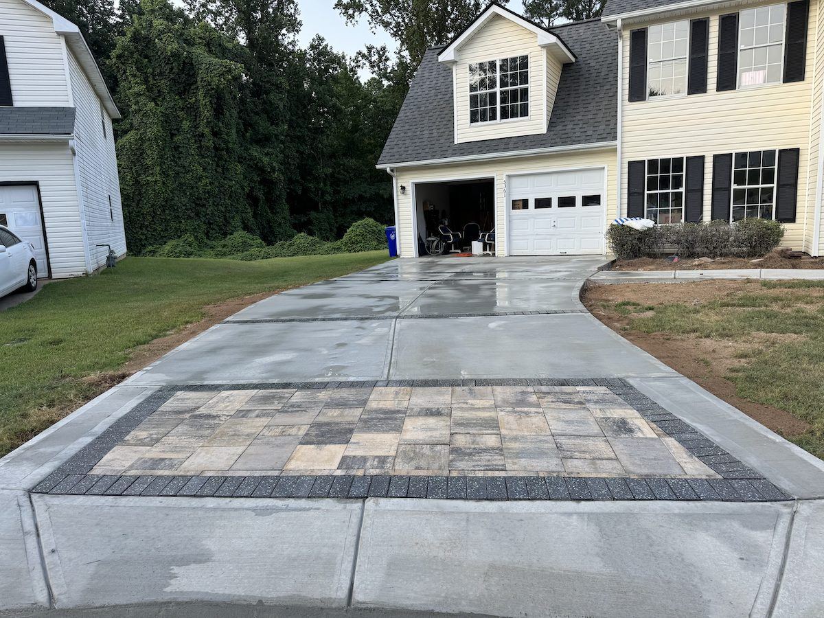Replaced concrete driveway with a paver apron and dark border in Lawrenceville, GA